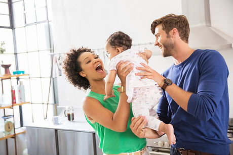 Happy young family with parents and baby