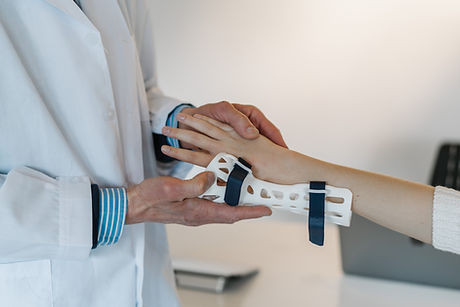 Doctor fitting wrist brace on patient during urgent care visit