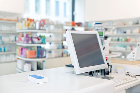 Pharmacy counter with computer monitor and shelves of products