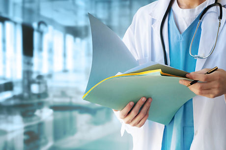 Doctor in white coat holding open medical file folder